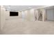 Spacious carpeted basement with recessed lighting, TV, and French doors leading outside at 535 Woodbrook Way, Lawrenceville, GA 30043