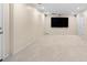Finished basement area with neutral carpet, TV, and access to the outside at 535 Woodbrook Way, Lawrenceville, GA 30043