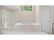 Bathroom featuring a soaking tub and glass enclosed shower at 535 Woodbrook Way, Lawrenceville, GA 30043