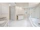 Well-lit bathroom with double vanities, soaking tub, and a glass-enclosed shower at 535 Woodbrook Way, Lawrenceville, GA 30043