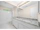 Bathroom featuring double sinks, granite countertops, and a shower-tub combo at 535 Woodbrook Way, Lawrenceville, GA 30043