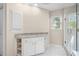 Bright bathroom with granite countertops, vanity sink, and glass-enclosed shower at 535 Woodbrook Way, Lawrenceville, GA 30043