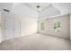 Bright bedroom with tray ceilings, plush carpeting, and ample closet space at 535 Woodbrook Way, Lawrenceville, GA 30043