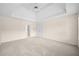 Bright bedroom with a tray ceiling, plush carpeting, and ample closet space at 535 Woodbrook Way, Lawrenceville, GA 30043