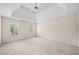 Spacious primary bedroom with a tray ceiling, neutral carpet, and natural light at 535 Woodbrook Way, Lawrenceville, GA 30043