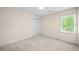 Neutral bedroom with a large window allowing lots of natural light at 535 Woodbrook Way, Lawrenceville, GA 30043