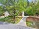 Suburban home with a long driveway and mature shade tree on a large lot at 535 Woodbrook Way, Lawrenceville, GA 30043