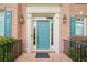 Stylish blue front door with white trim, flanked by sconces and shutters at 535 Woodbrook Way, Lawrenceville, GA 30043