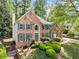 Charming brick home featuring a well-manicured lawn and teal shutters at 535 Woodbrook Way, Lawrenceville, GA 30043