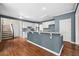 Kitchen island with bar seating, modern cabinets, and hardwood floors at 535 Woodbrook Way, Lawrenceville, GA 30043