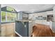 Open kitchen with marble countertops, white cabinets, and hardwood floors at 535 Woodbrook Way, Lawrenceville, GA 30043