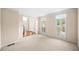 Bright, carpeted living room with large windows and elegant trim at 535 Woodbrook Way, Lawrenceville, GA 30043