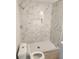 Modern walk-in shower with white marble-patterned tiling and white hexagonal tile floor at 4080 Brushymill Ct, Loganville, GA 30052