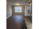 Dining area with wood floors, a window for natural light, and stylish gray cabinets at 4080 Brushymill Ct, Loganville, GA 30052
