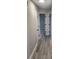 Hallway featuring neutral gray walls, crisp white trim, luxury vinyl plank flooring and doors to the bedrooms at 4080 Brushymill Ct, Loganville, GA 30052