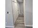 Long, narrow hallway with gray walls, wood floors, and multiple white doors at 4080 Brushymill Ct, Loganville, GA 30052