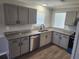 Updated kitchen with granite countertops, gray cabinets, stainless steel sink, and stainless appliances at 4080 Brushymill Ct, Loganville, GA 30052