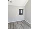 Bright living room featuring gray walls and luxury vinyl plank flooring, with a pass-through to the kitchen at 4080 Brushymill Ct, Loganville, GA 30052