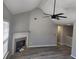 Living room featuring vaulted ceiling, modern fan and fireplace at 4080 Brushymill Ct, Loganville, GA 30052