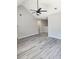 Spacious living room featuring gray walls, a ceiling fan, luxury vinyl plank flooring, and a vaulted ceiling at 4080 Brushymill Ct, Loganville, GA 30052