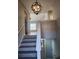 A well-lit staircase with modern wood-look flooring ascends to the upper level of the home at 4080 Brushymill Ct, Loganville, GA 30052