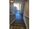 Staircase featuring wood-look steps leads to a landing with a white door and an overhead light fixture at 4080 Brushymill Ct, Loganville, GA 30052