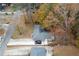 Aerial view of home surrounded by mature trees and long driveways at 679 Winchester Ln, Norcross, GA 30071