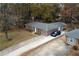 Charming single story home with long driveway and detached garage surrounded by mature trees at 679 Winchester Ln, Norcross, GA 30071