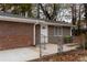 Backyard with brick and tan siding, chain link fence, and small patio at 679 Winchester Ln, Norcross, GA 30071