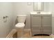 Bathroom with a toilet, gray vanity, and tile flooring at 679 Winchester Ln, Norcross, GA 30071