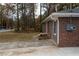 Brick exterior of home with sidewalk to the side and neutral colored siding at 679 Winchester Ln, Norcross, GA 30071