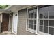 Rear view showing a modern siding and brick exterior with white trim, and windows overlooking the backyard at 679 Winchester Ln, Norcross, GA 30071