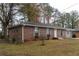 Brick home with updated siding and manicured lawn showcasing its charm and curb appeal at 679 Winchester Ln, Norcross, GA 30071