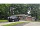 Landscaped home featuring brick and siding, neutral tones, and a spacious driveway for parking at 679 Winchester Ln, Norcross, GA 30071