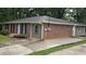 Brick home featuring tidy landscaping, and a concrete driveway, adding to its curb appeal at 679 Winchester Ln, Norcross, GA 30071