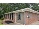 Exterior of a single-story house featuring a brick facade, dark shutters, and neutral-toned siding at 679 Winchester Ln, Norcross, GA 30071