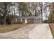 Charming brick home with a well-maintained lawn and long driveway at 679 Winchester Ln, Norcross, GA 30071