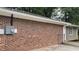 Exterior of home featuring red brick, vinyl siding, and a well-maintained yard at 679 Winchester Ln, Norcross, GA 30071