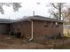 Back exterior of brick home with neutral colored siding at 679 Winchester Ln, Norcross, GA 30071
