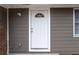Inviting front entry features a bright white door with decorative window and secure deadbolt at 679 Winchester Ln, Norcross, GA 30071