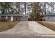 Inviting brick home with a concrete driveway, offering ample parking space and a welcoming entrance at 679 Winchester Ln, Norcross, GA 30071