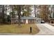 Charming brick home with a well-kept lawn, highlighting the property's classic appeal and curb appeal at 679 Winchester Ln, Norcross, GA 30071