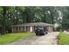 Lovely brick home with a long driveway, lush lawn, and mature trees providing shade and curb appeal at 679 Winchester Ln, Norcross, GA 30071