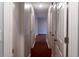 Hallway featuring a dark red floor and multiple white doors, leading to another area at 679 Winchester Ln, Norcross, GA 30071