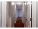 Hallway with white walls and multiple doors, leading towards a brighter area in the distance at 679 Winchester Ln, Norcross, GA 30071