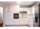 Kitchen features stainless steel refrigerator, white cabinets, and a modern oven at 679 Winchester Ln, Norcross, GA 30071