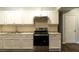 Well-lit kitchen featuring white cabinets, stainless steel appliances, and a modern design at 679 Winchester Ln, Norcross, GA 30071