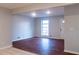 Bright living room with hardwood floors and a large window providing natural light and an entrance door at 679 Winchester Ln, Norcross, GA 30071
