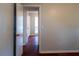 An open doorway leads into a room, featuring wooden floors and a window at the end at 679 Winchester Ln, Norcross, GA 30071