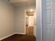 A view of a room with an open door, neutral walls, and visible hallway beyond at 679 Winchester Ln, Norcross, GA 30071